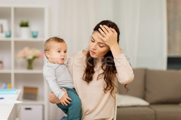tired mother with baby boy at home Stock photo © dolgachov