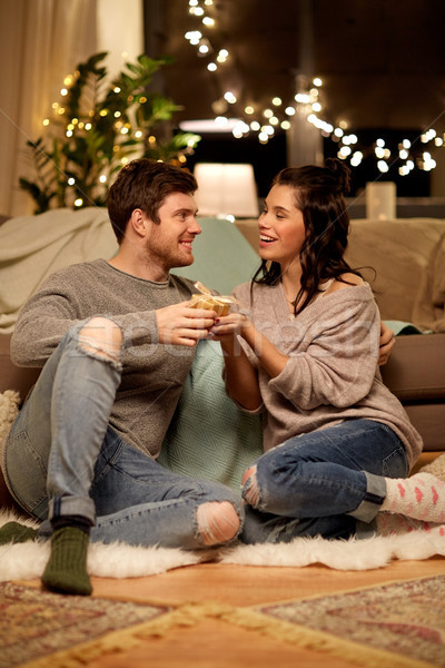happy couple with gift box at home Stock photo © dolgachov