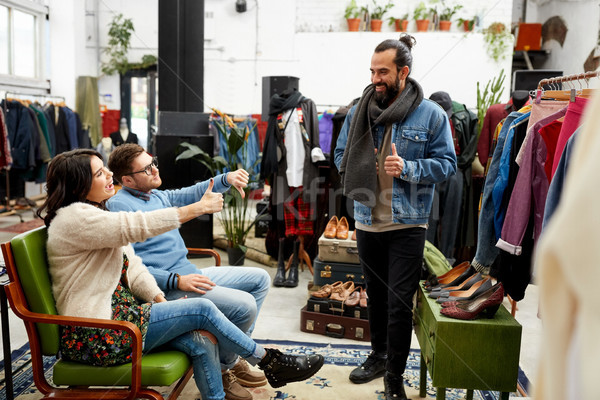 friends choosing clothes at vintage clothing store Stock photo © dolgachov