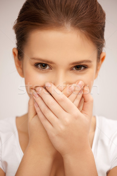 woman with hand over mouth Stock photo © dolgachov