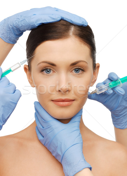 woman face and beautician hands Stock photo © dolgachov