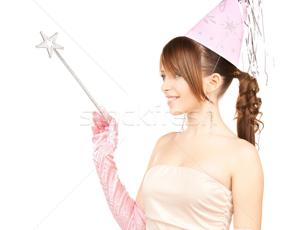 girl in party cap with magic stick Stock photo © dolgachov