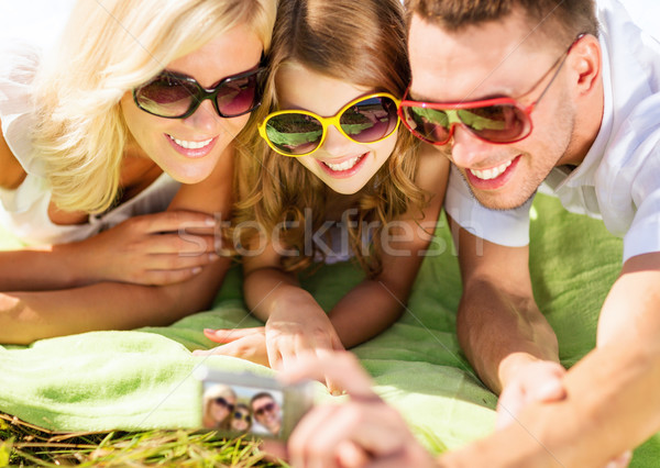 happy family with camera taking picture Stock photo © dolgachov