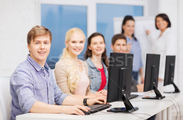Stock photo: students with computer monitor at school