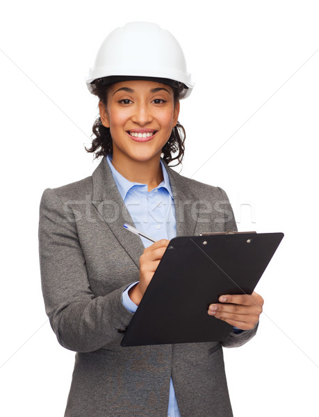 businesswoman in white helmet with clipboard Stock photo © dolgachov