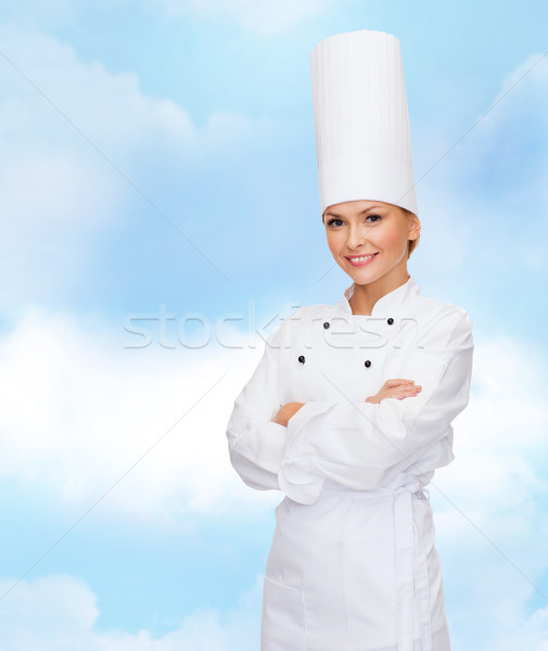 smiling female chef with crossed arms Stock photo © dolgachov