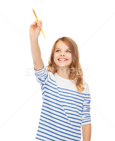 cute little girl drawing with brush in the air Stock photo © dolgachov
