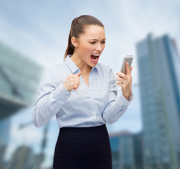 Stock photo: screaming businesswoman with smartphone