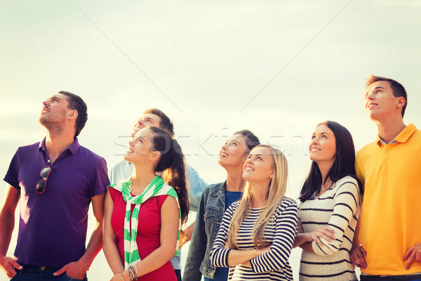 group of friends looking up on the beach Stock photo © dolgachov