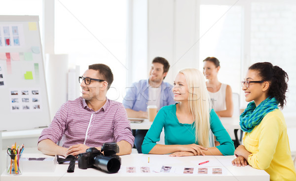 smiling team with photocamera working in office Stock photo © dolgachov
