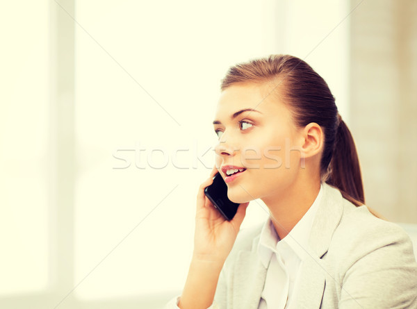 Stock photo: businesswoman with smartphone in office