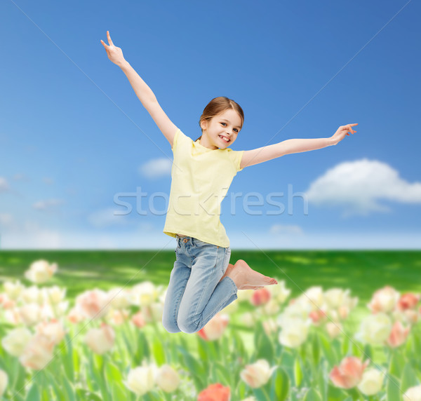 smiling little girl jumping Stock photo © dolgachov