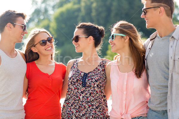 group of smiling friends in city Stock photo © dolgachov