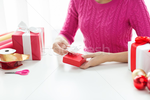 close up of woman decorating christmas presents Stock photo © dolgachov