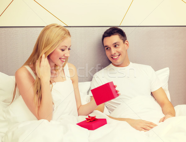 man giving woman little red gift box Stock photo © dolgachov