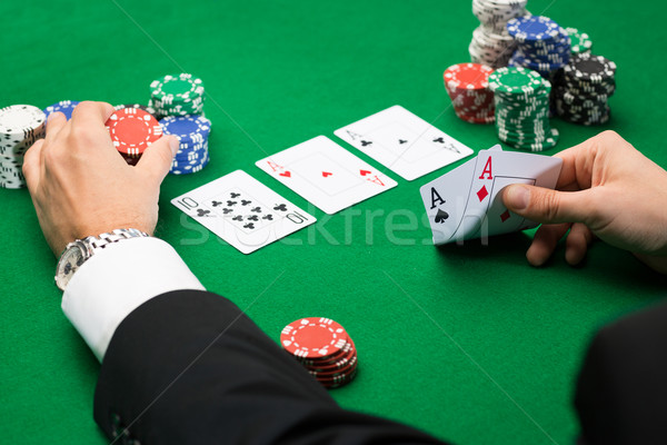 Stock photo: poker player with cards and chips at casino