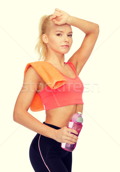 tired sporty woman with towel and water bottle Stock photo © dolgachov