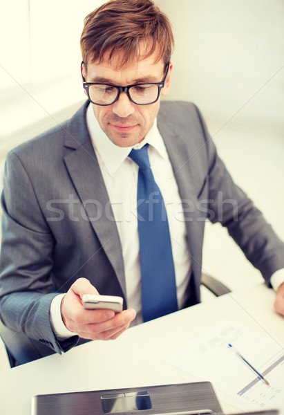 Stock photo: businessman working with laptop and smartphone