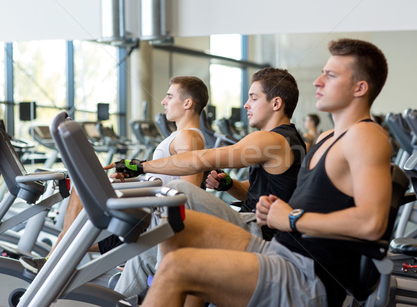 men working out on exercise bike in gym Stock photo © dolgachov