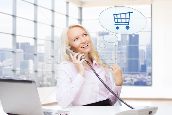 smiling businesswoman calling on telephone Stock photo © dolgachov