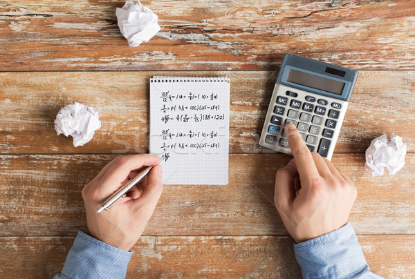 close up of hands with calculator solving task Stock photo © dolgachov