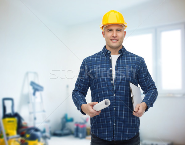 smiling male builder in helmet with blueprint Stock photo © dolgachov