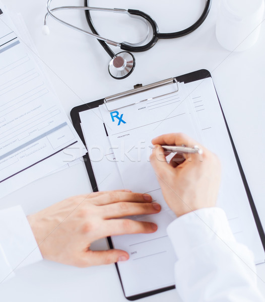 male doctor writing prescription paper Stock photo © dolgachov