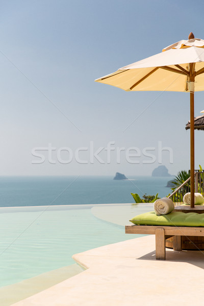 view from infinity edge pool with parasol to sea Stock photo © dolgachov