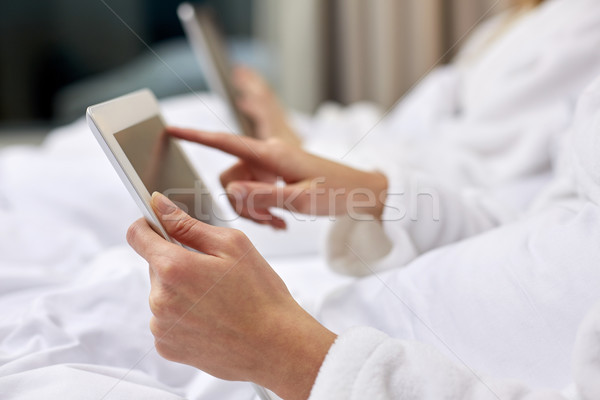 close up of woman hands in bathrobe with tablet pc Stock photo © dolgachov
