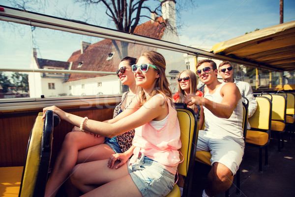 Stock photo: group of smiling friends traveling by tour bus