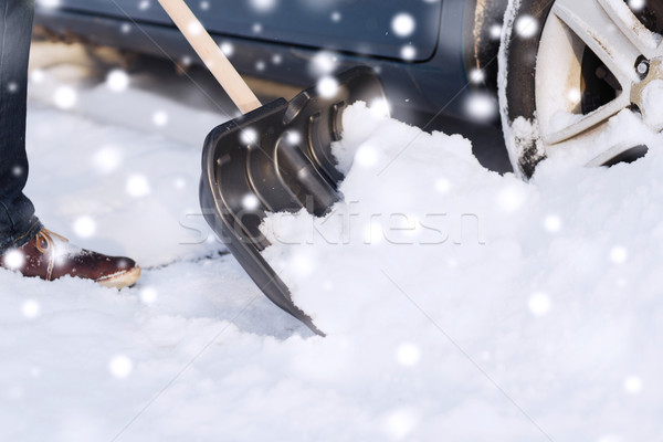 Stock photo: closeup of man digging snow with shovel near car