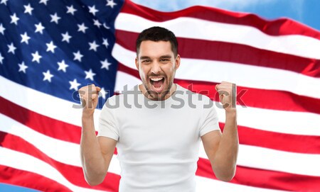 Mérges férfi mutat amerikai zászló érzelmek állampolgárság Stock fotó © dolgachov