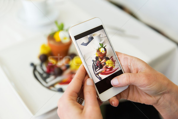 close up of woman picturing food by smartphone Stock photo © dolgachov