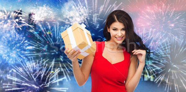 happy woman in red dress with gift over firework Stock photo © dolgachov
