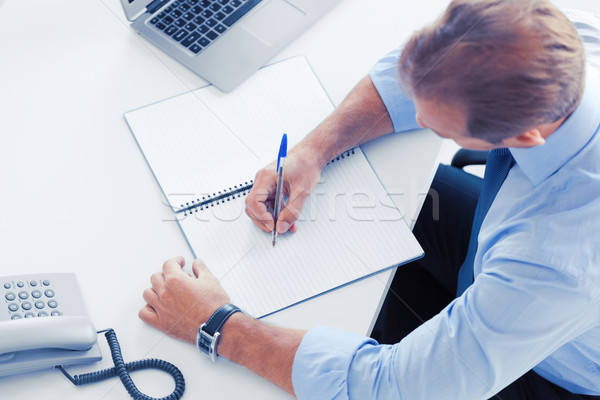 businessman writing in notebook Stock photo © dolgachov