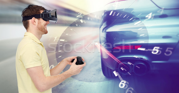 man in virtual reality headset and car racing game Stock photo © dolgachov