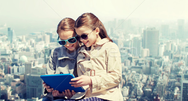 happy girls with tablet pc computer over city Stock photo © dolgachov