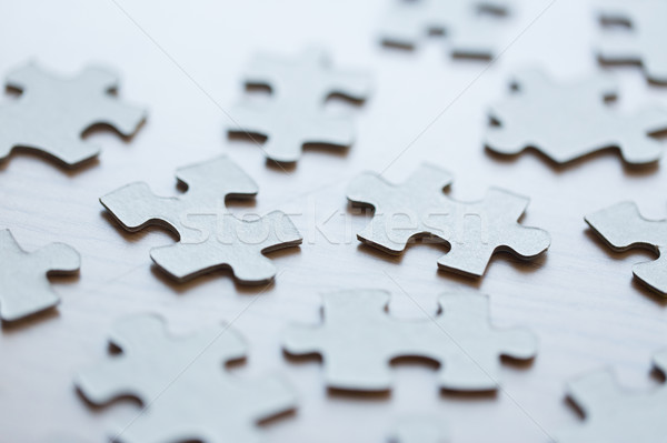 close up of puzzle pieces on table Stock photo © dolgachov