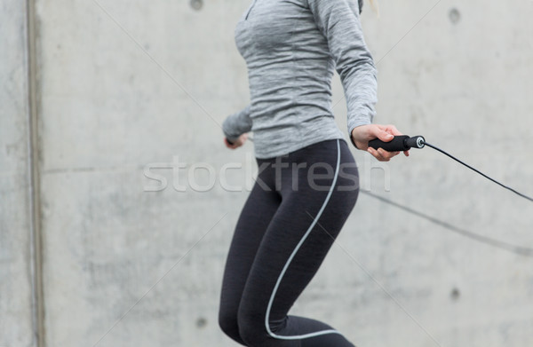 close up of woman exercising with jump-rope Stock photo © dolgachov