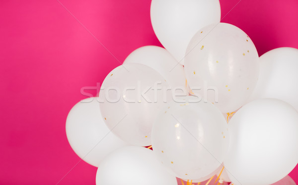 close up of white helium balloons over pink Stock photo © dolgachov