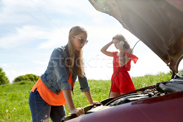 Stock photo: women with open hood of broken car at countryside