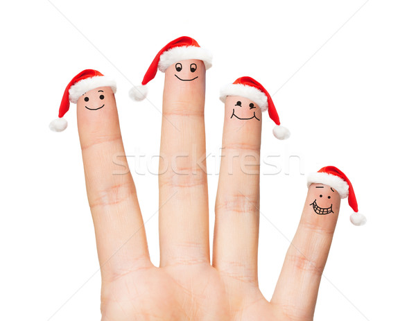 close up of hand with four fingers in santa hats Stock photo © dolgachov