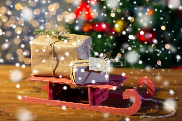 close up of christmas gift boxes on wooden sleigh Stock photo © dolgachov