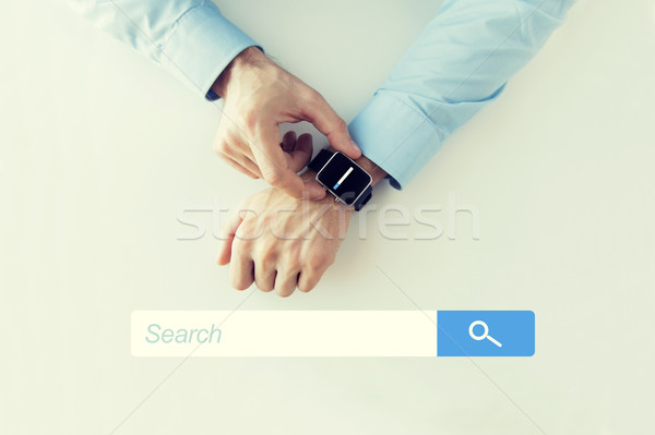 hands with internet browser search on smartwatch Stock photo © dolgachov