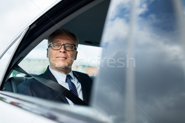 Idős üzletember vezetés autó hát ülés Stock fotó © dolgachov
