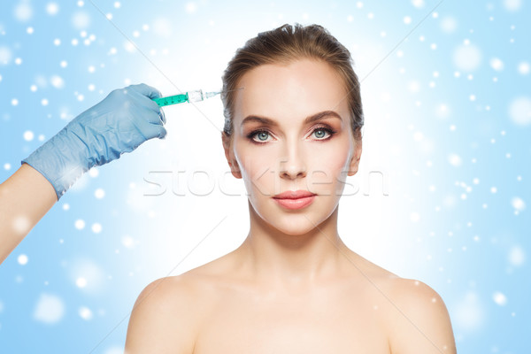 Cara da mulher mão seringa injeção pessoas Foto stock © dolgachov