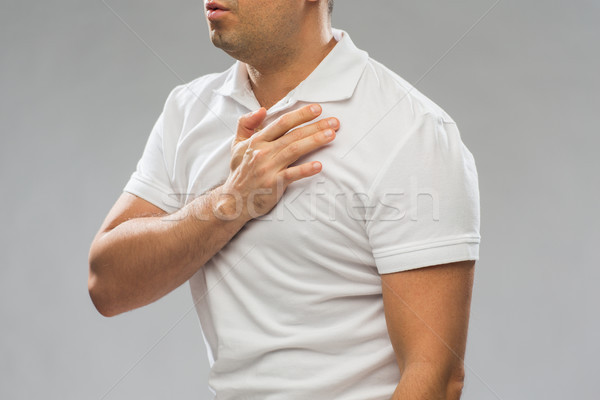 close up of man with heart ache or chest pain Stock photo © dolgachov