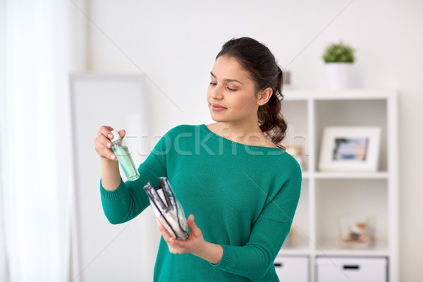 woman packing cosmetics to cosmetic bag at home Stock photo © dolgachov