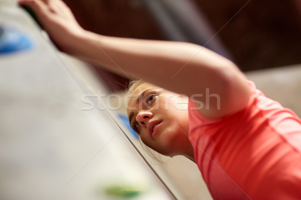 young woman exercising at indoor climbing gym wall Stock photo © dolgachov