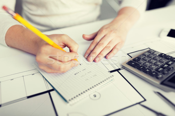 close up of architect hand writing to notebook Stock photo © dolgachov